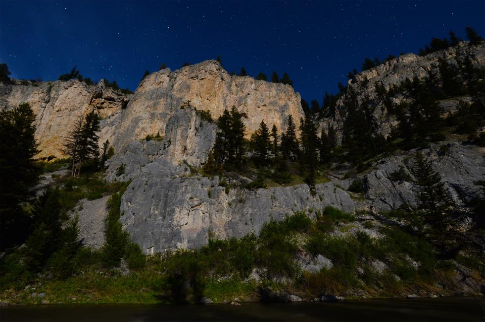 Moonlit cliffs overlooking the Merganser campground on the Smith River. The Smith River State Park recreational corridor is a 59-mile stretch requiring a float permit that starts at Camp Baker located near White Sulphur Springs and finishes at Eden. The corridor is managed cooperatively by Montana Fish Wild Life and Parks and the US Forest Service.