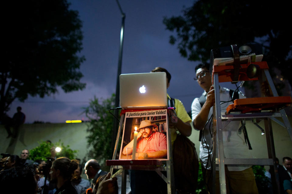 <p>A pair of young men project a video and slideshow from atop ladders, one decorated with a picture of murdered journalist Javier Valdez, during a protest in front of the Interior Ministry in Mexico City, Tuesday, May 16, 2017. (AP Photo/Rebecca Blackwell) </p>