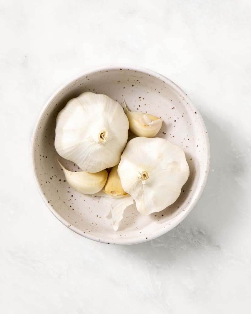 garlic in a small bowl on a marble surface