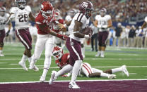 Texas A&M wide receiver Ainias Smith carries the ball across the goal line past Arkansas defensive back Greg Brooks Jr. (9) to score a touchdown during the first half of an NCAA college football game Saturday, Sept. 28, 2019, in Arlington, Texas. (AP Photo/Ron Jenkins)