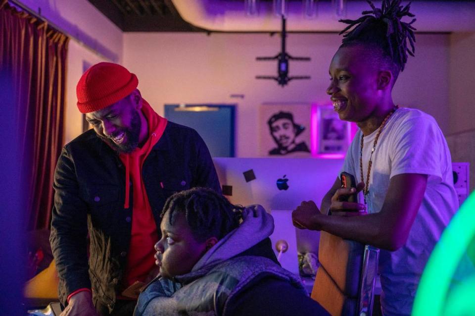 Joseph Macklin, left, replays an audio recording to students Ajahnae Henderson, center, and Antonio Bly during a music class at Distrikt Studios. Macklin mentors students from DeLaSalle Education Center, teaching them how to compose and produce music.