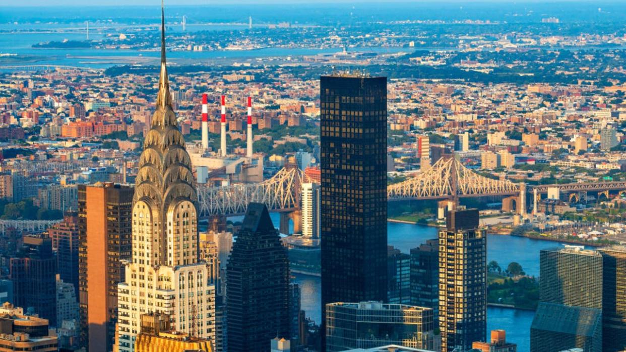 <div>The top of the art deco Chrysler Building glowing at sunset. Taken from the top of the Empire State Building. Also in shot is the Queensboro Bridge. (Photo by: Sergi Reboredo/VW Pics/Universal Images Group via Getty Images)</div>