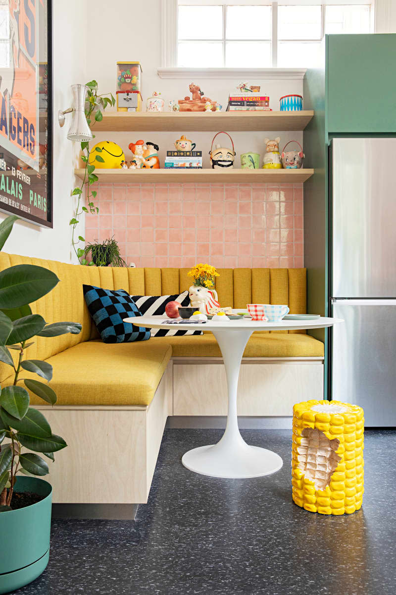 Corn cushion on floor in newly renovated pink tiled kitchen.