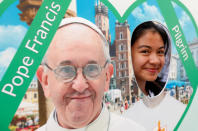 <p>A pilgrim poses next to a picture of Pope Francis at the main square during World Youth Day in Krakow, Poland, July 26, 2016. (REUTERS/David W Cerny)</p>