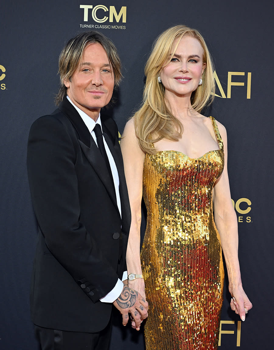 nicole kidman wears gold balenciaga dress and omega watch, HOLLYWOOD, CALIFORNIA - APRIL 27: Keith Urban and Nicole Kidman attend the 49th AFI Life Achievement Award Gala Tribute Celebrating Nicole Kidman at Dolby Theatre on April 27, 2024 in Hollywood, California. (Photo by Axelle/Bauer-Griffin/FilmMagic)