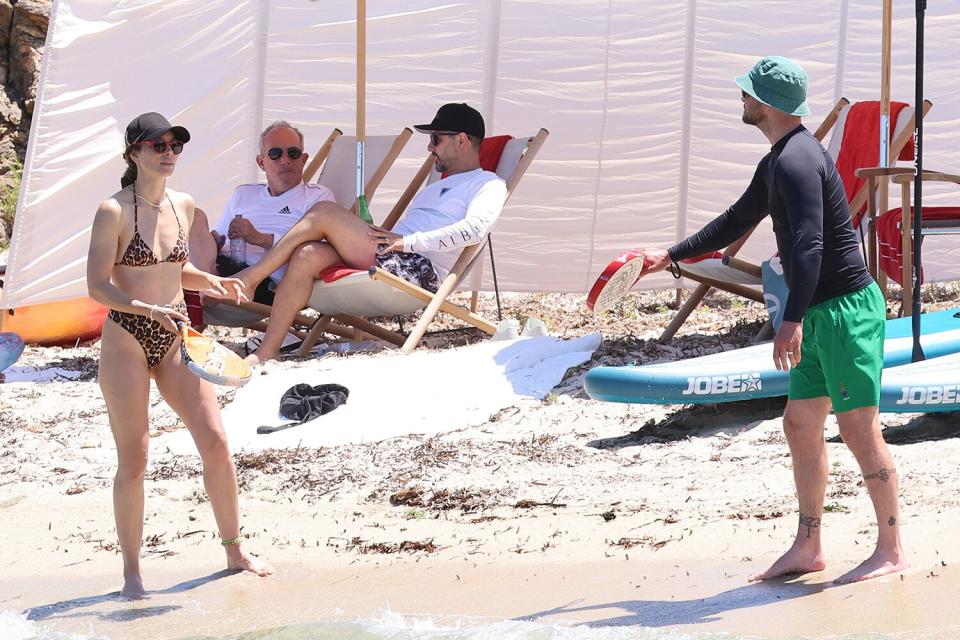 Justin Timberlake And Wife Jessica Biel On A Beach Playing Paddle