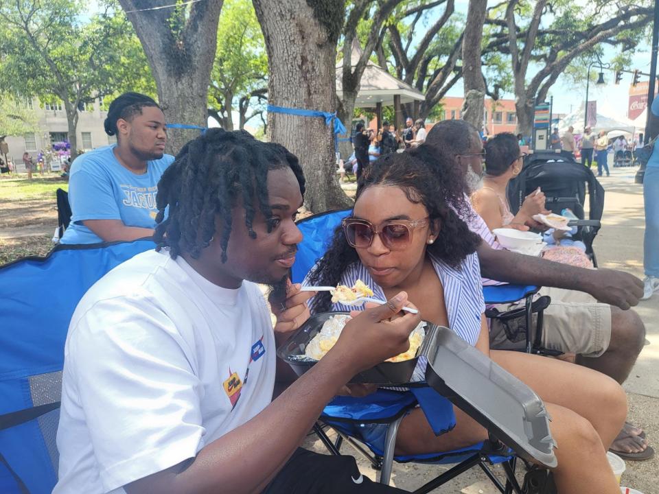 A.B. Bradley and his fiancé Rayghan James eat a "Mac Daddy" during Twinfest Louisiana, April 6 in Downtown Houma.