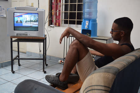 A Cuban stranded in Mexico watches the news at a hotel after fellow nationals were deported in Tapachula, Mexico January 20, 2017. REUTERS/Jose Torres