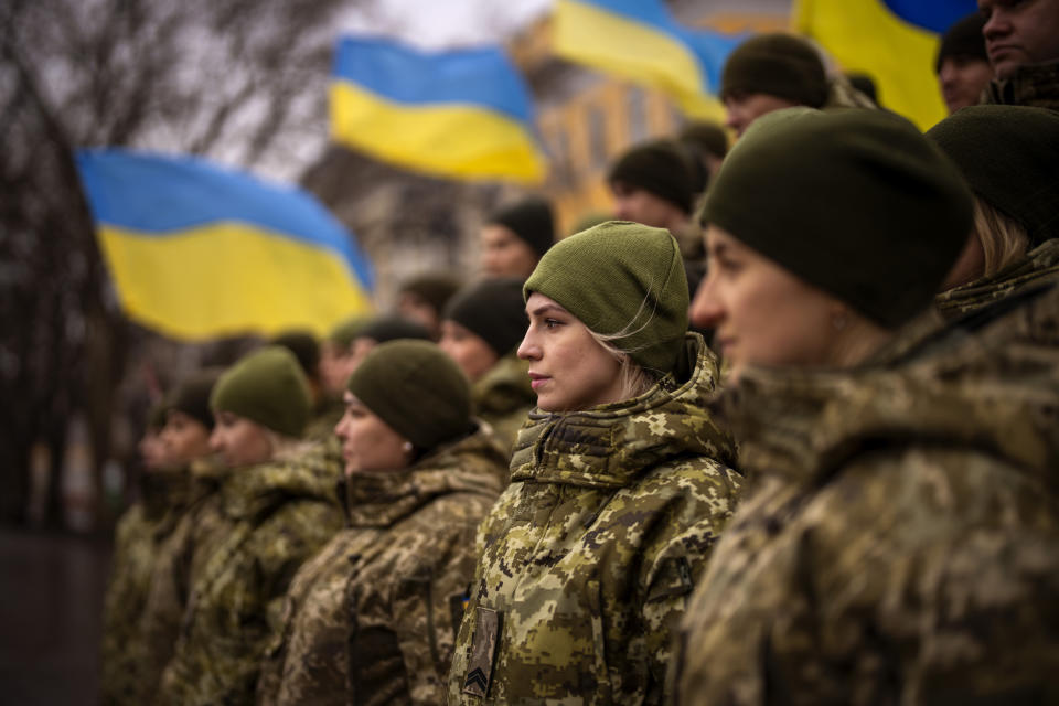 Ukrainian Army soldiers pose for a photo as they gather to celebrate a Day of Unity in Odessa, Ukraine, Wednesday, Feb. 16, 2022. As Western officials warned a Russian invasion could happen as early as today, the Ukrainian President Zelenskyy called for a Day of Unity, with Ukrainians encouraged to raise Ukrainian flags across the country. (AP Photo/Emilio Morenatti)