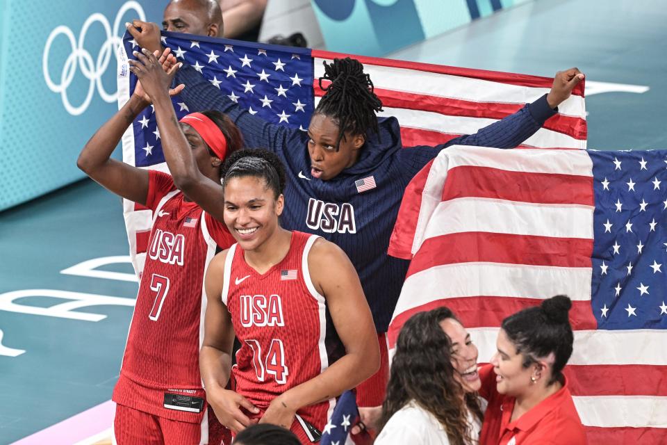 USA's players celebrate winning the women's Gold Medal basketball match between France and the USA during the Paris 2024 Olympic Games at the Bercy Arena in Paris on August 11, 2024. (Photo by Damien MEYER / AFP) (Photo by DAMIEN MEYER/AFP via Getty Images) ORIG FILE ID: 2165851172