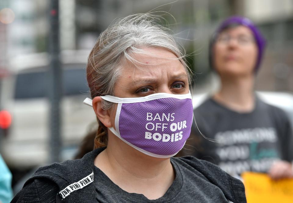 M.A. Allgeier of Louisville wears a face mask showing her stance on body autonomy at a pro-choice rally outside the Hall of Justice, Tuesday, May 03, 2022, in Louisville, Ky.
