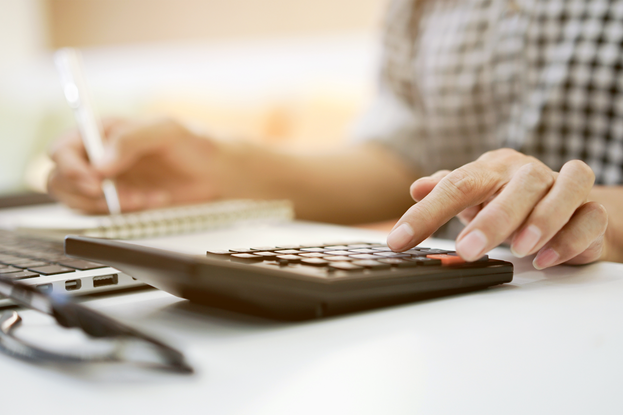 Close-up of woman's hands using calculator