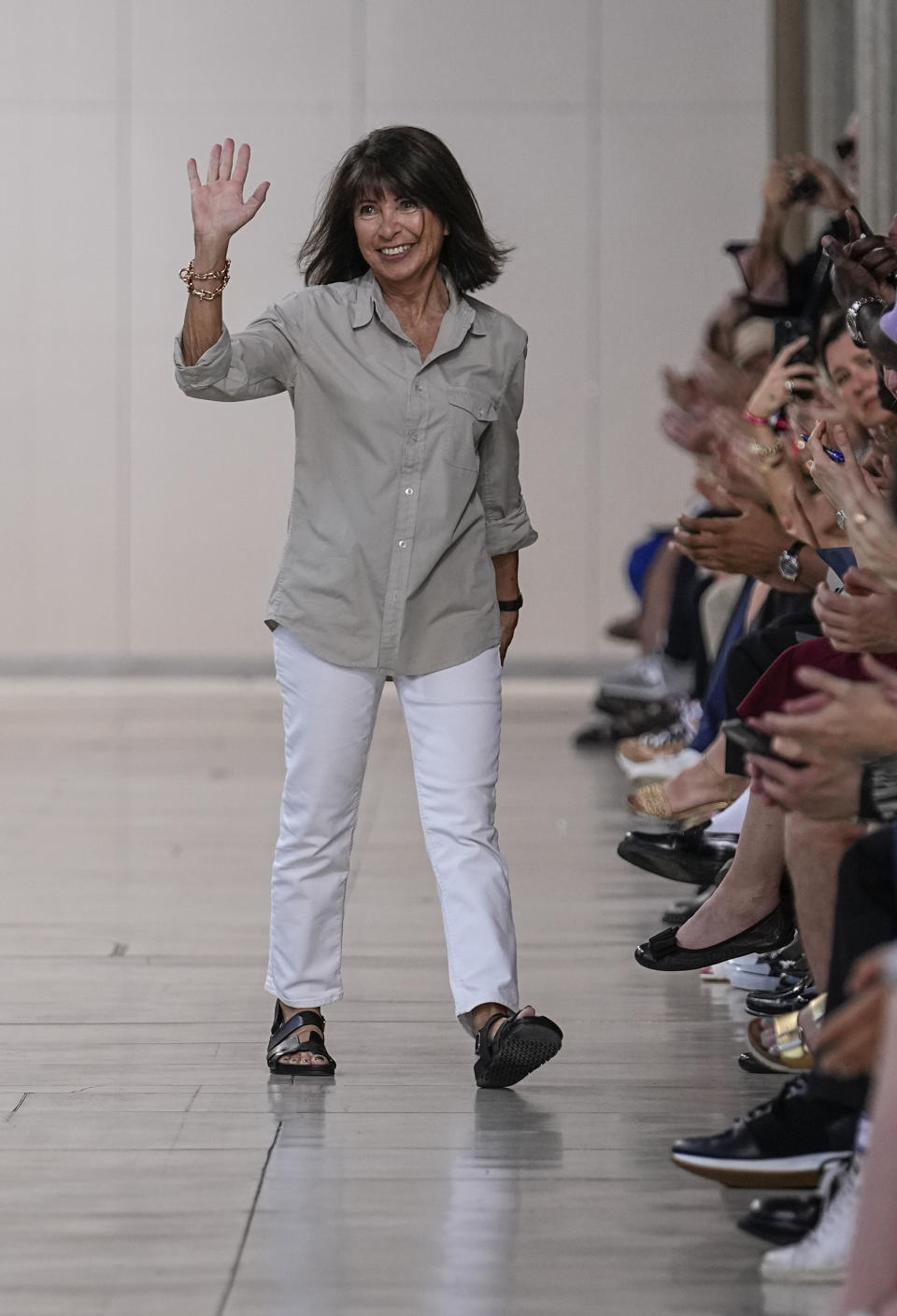 Designer Veronique Nichanian accepts applause after the conclusion of the Hermes Menswear Spring/Summer 2024 fashion collection presented in Paris, Saturday, June 24, 2023. (AP Photo/Michel Euler)