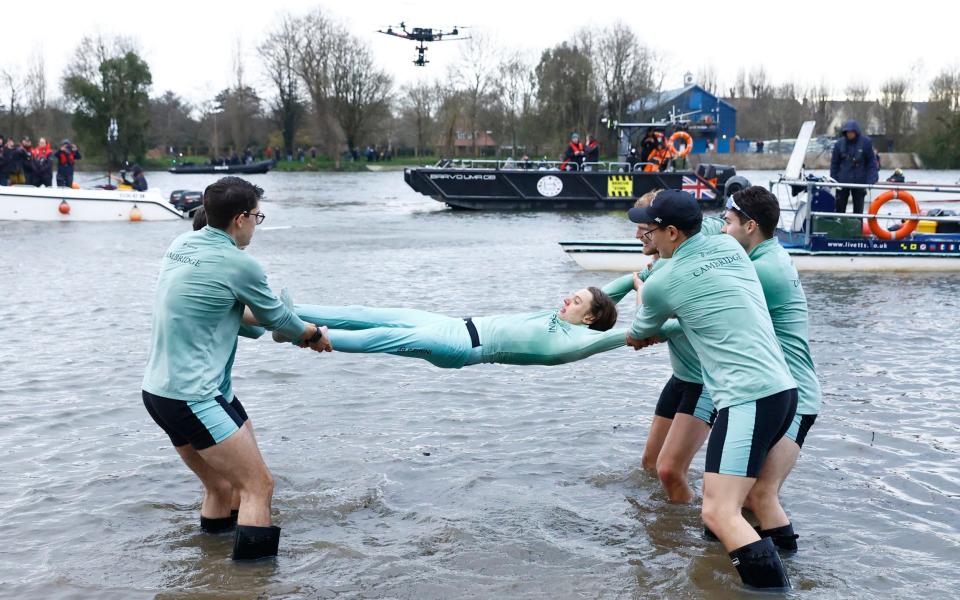 Cambridge coxswain Jasper Parish is thrown in the river by teammates - Action Images via Reuters/Andrew Boyers