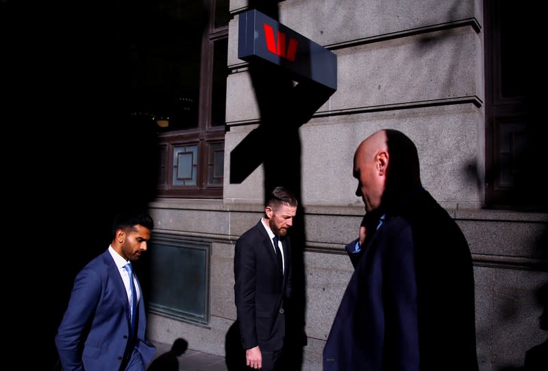 FILE PHOTO: Pedestrians walk past a branch of the Westpac Banking Corporation in central Sydney