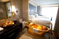 A gold plated bathtub and a gold plated bathroom sink are seen in the newly-inaugurated Dolce Hanoi Golden Lake luxury hotel, after the government eased a nationwide lockdown following the global outbreak of the coronavirus disease (COVID-19), in Hanoi