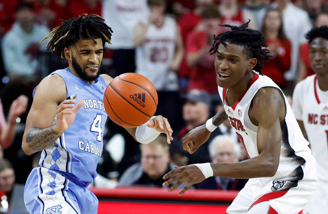North Carolina’s R.J. Davis (4) and N.C. State’s Terquavion Smith (0) go for the ball during the second half of N.C. State’s 77-69 victory over UNC at PNC Arena in Raleigh, N.C., Sunday, Feb. 19, 2023.