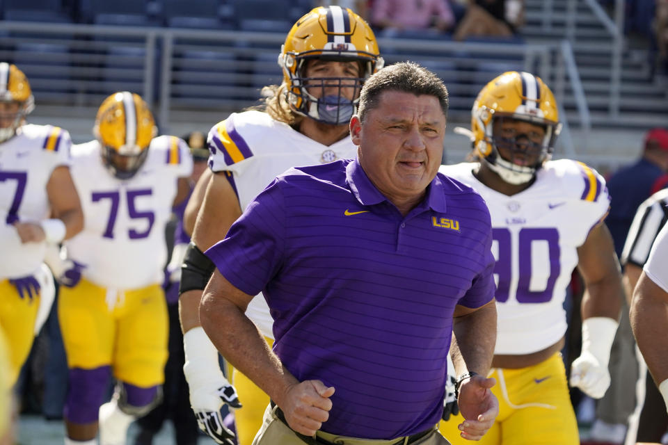 LSU head coach Ed Orgeron leads his team to the field before an NCAA college football game against Mississippi in Oxford, Miss., Saturday, Oct. 23, 2021. (AP Photo/Rogelio V. Solis)