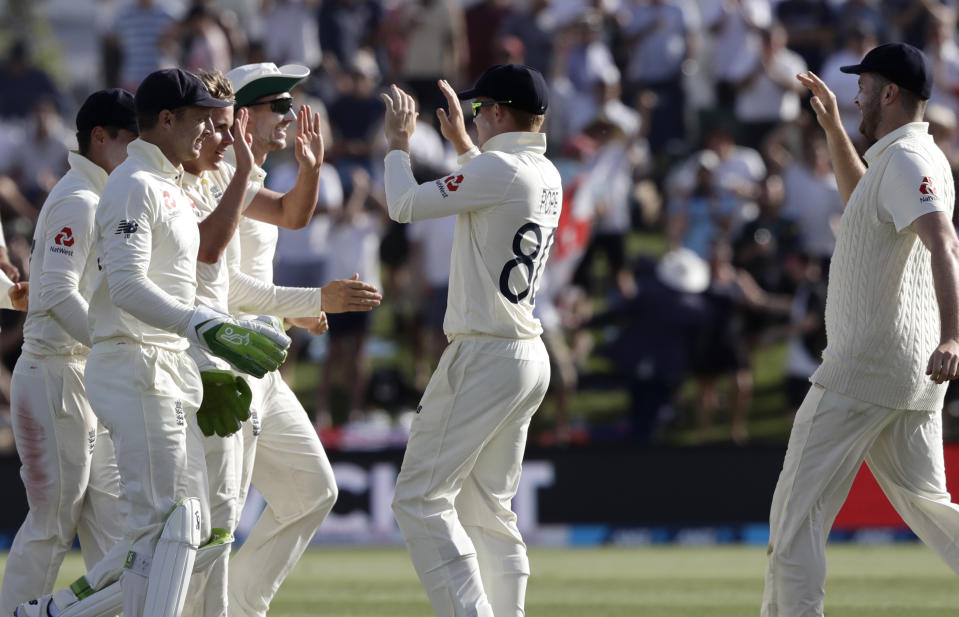England players celebrate the dismissal of New Zealand's Kane Williamson during play on day two of the first cricket test between England and New Zealand at Bay Oval in Mount Maunganui, New Zealand, Friday, Nov. 22, 2019. (AP Photo/Mark Baker)