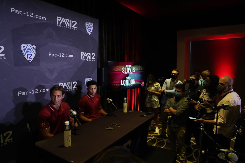 Southern California quarterback Keldon Slovis, left, and wide receiver Drake London answer questions during the Pac-12 Conference NCAA college football Media Day Tuesday, July 27, 2021, in Los Angeles. (AP Photo/Marcio Jose Sanchez)