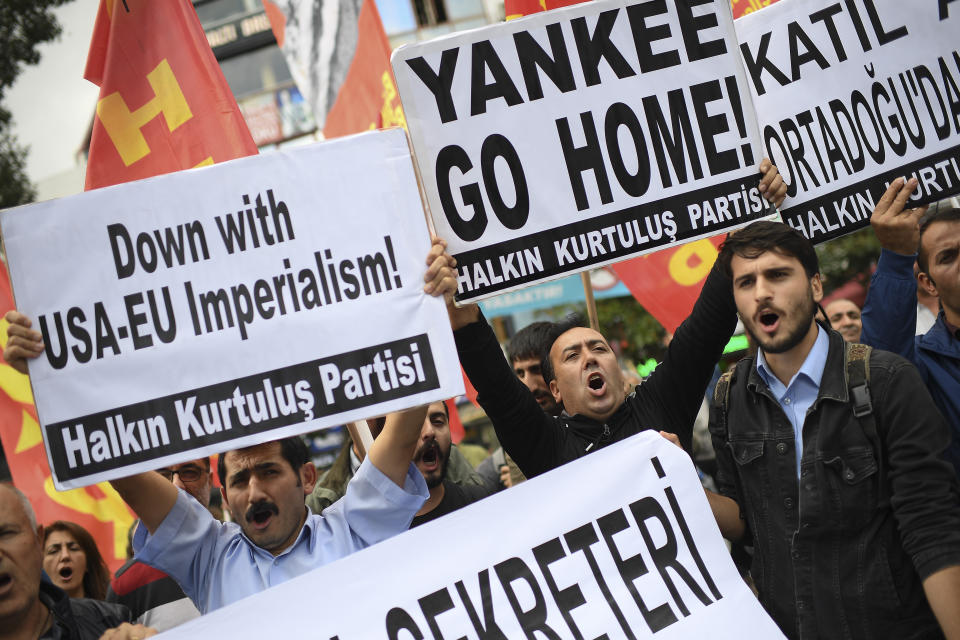 Members of a leftist group stage a protest against the NATO and the war in Syria, in Istanbul, Friday, Oct. 11, 2019. Turkish forces pushed deeper into northeastern Syria on Friday, the third day of Ankara's cross-border offensive against Syrian Kurdish fighters that has set off another mass displacement of civilians and met with widespread criticism from the international community.(AP Photo/Akin Celiktas)