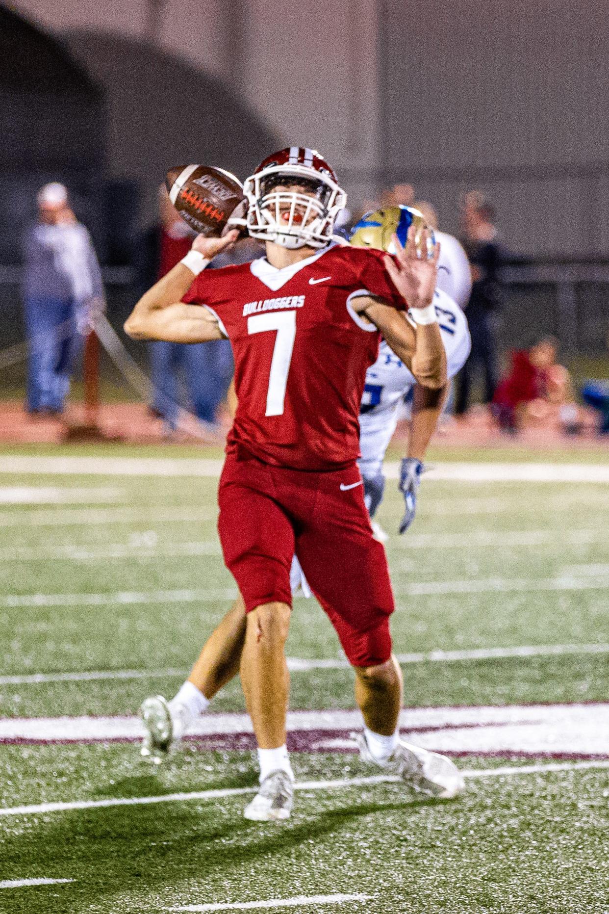 Dewey's Trenton Muninger throws a pass and is tackled in the process during a home game last October vs. Rejoice Christian.