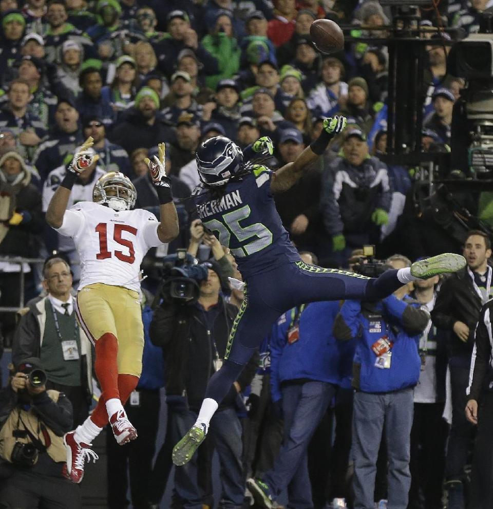 Seattle Seahawks' Richard Sherman tips a pass intended for San Francisco 49ers' Michael Crabtree (15) in the final seconds of the second half of the NFL football NFC Championship game Sunday, Jan. 19, 2014, in Seattle. Malcolm Smith intercepted the tipped pass. The Seahawks won 23-17 to advance to Super Bowl XLVIII. (AP Photo/Marcio Jose Sanchez)