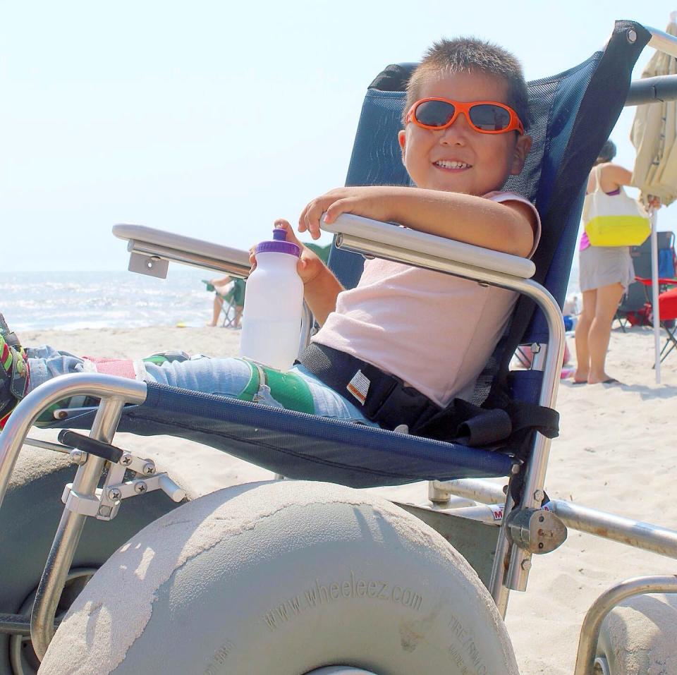 Jaden Allen, 5, of Elizabethtown, Pa., enjoys the beach thanks to beach wheelchairs designed not to get bogged down in the sand.