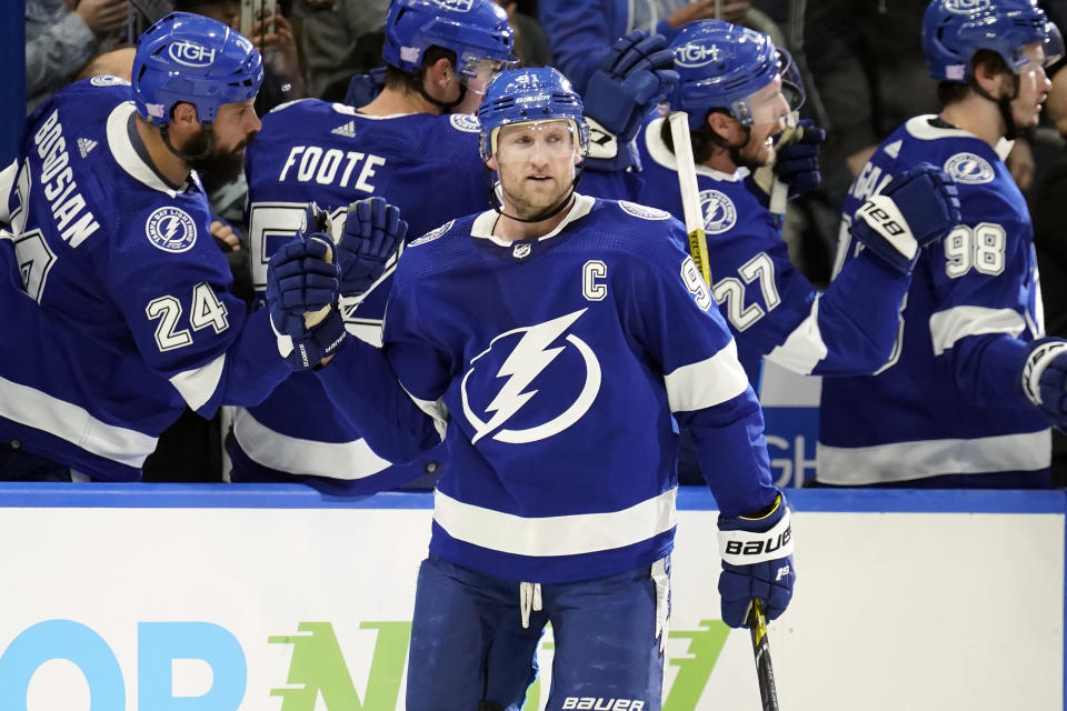 Tampa Bay Lightning center Steven Stamkos (91) celebrates his goal against the Seattle Kraken with the bench during the third period of an NHL hockey game Friday, Nov. 26, 2021, in Tampa, Fla. (AP Photo/Chris O'Meara)