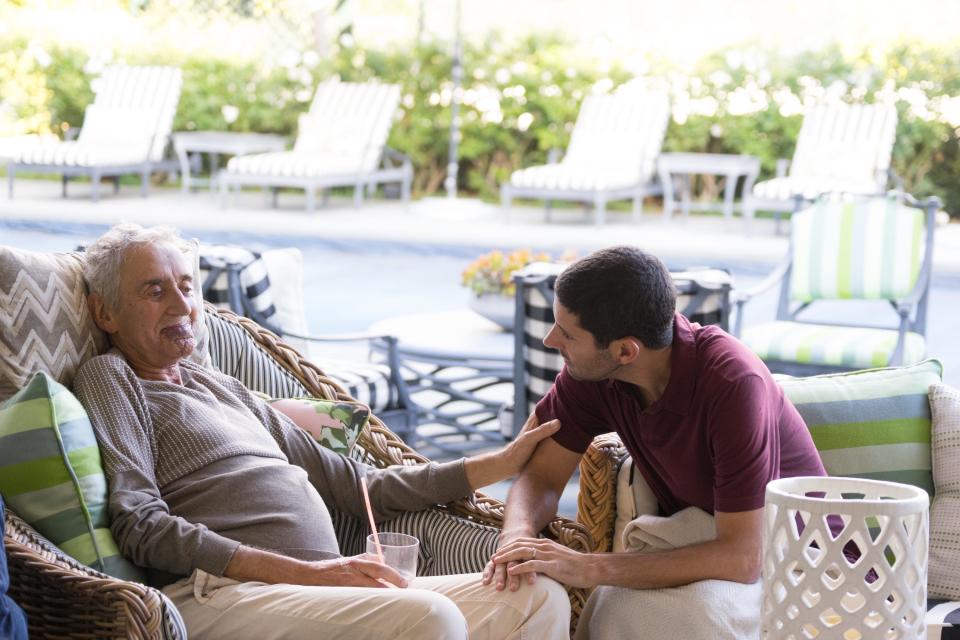 Alan Smolinisky talks with his father, Mario, in 2016. Mario died the next day.