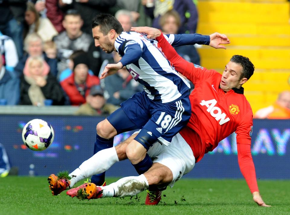Manchester United's Robin van Persie tackles West Brom's Morgan Amalfitano during the English Premier League soccer match between West Bromwich Albion and Manchester United at The Hawthorns Stadium in West Bromwich, England, Saturday, March 8, 2014. (AP Photo/Rui Vieira)