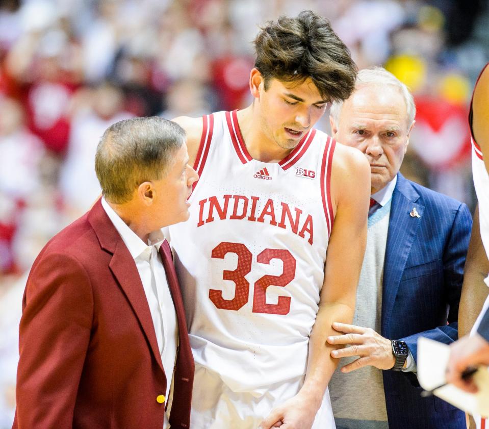 Indiana's Trey Galloway (32) is escorted off the floor after a hard foul during the first half the Indiana versus St. John's men's basketball game at Simon Skjodt Assembly Hall on Wednesday, Nov. 17, 2021.