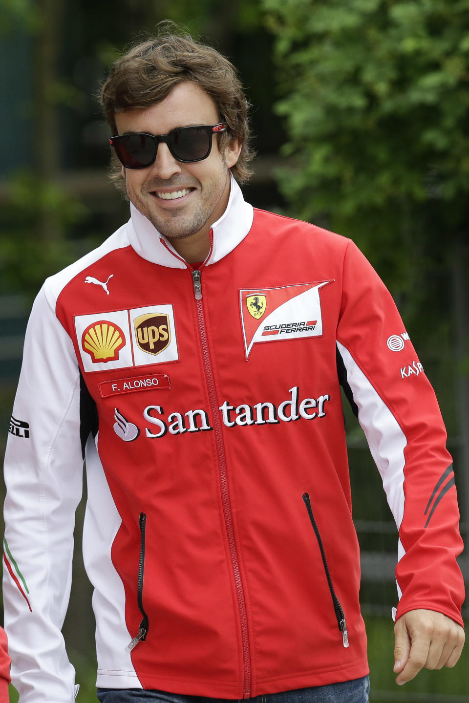 Ferrari driver Fernando Alonso of Spain walks at the paddock before a practice session ahead of Sunday's Chinese Formula One Grand Prix at Shanghai International Circuit in Shanghai, China, Friday, April 18, 2014. (AP Photo/Alexander F. Yuan)