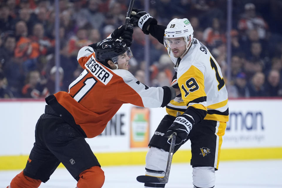 Pittsburgh Penguins' Reilly Smith, right, and Philadelphia Flyers' Tyson Foerster collide during the third period of an NHL hockey game, Monday, Jan. 8, 2024, in Philadelphia. (AP Photo/Matt Slocum)