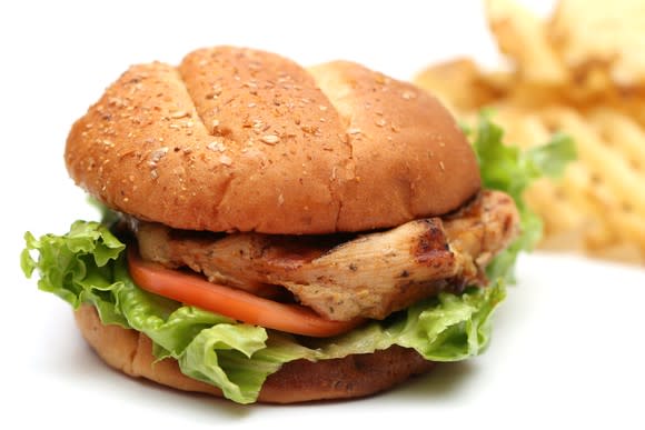 A chicken sandwich with fries.