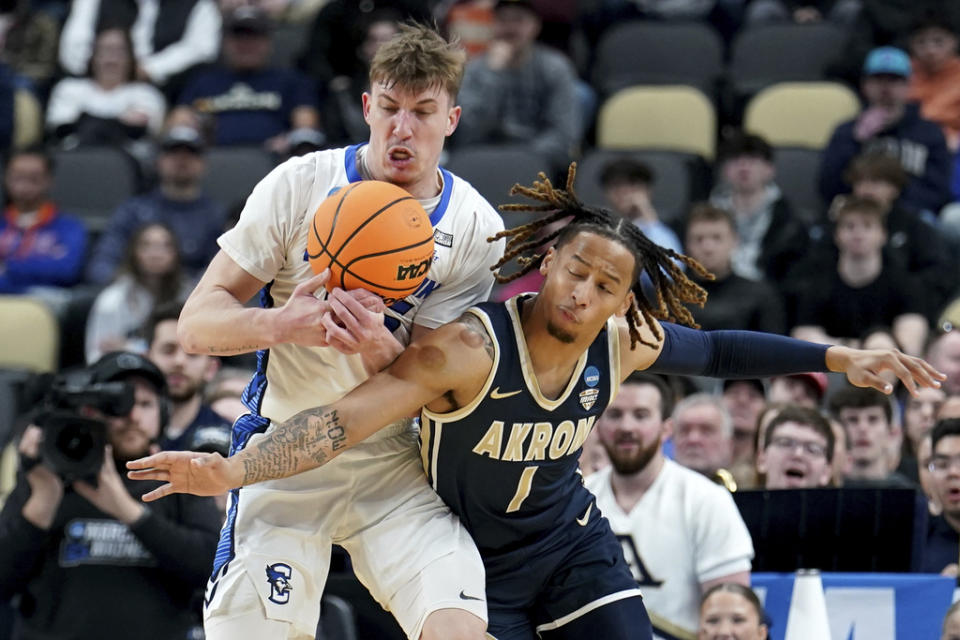 Creighton’s Baylor Scheierman reaches for a loose ball against Akron’s Shammah Scott during the first half of a first-round college basketball game in the NCAA Tournament, Thursday, March 21, 2024, in Pittsburgh. (AP Photo/Matt Freed)