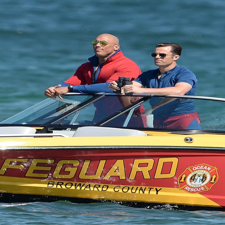 The bodyguards standing in a boat labeled 