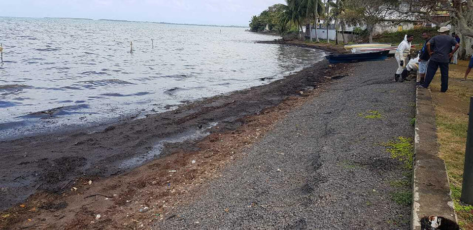 This photo taken and provided by Sunil Dowarkasing, showing oil polluting the foreshore on the eastern side of Mauritius, after it leaked from the MV Wakashio, a bulk carrier ship that recently ran aground off the southeast coast of Mauritius, Sunday, Aug. 9, 2020. Residents of the Indian Ocean island nation of Mauritius are stuffing fabric sacks with sugar cane leaves to create makeshift oil spill barriers as tons of fuel has leaked from a grounded ship. (Sunil Dowarkasing via AP)