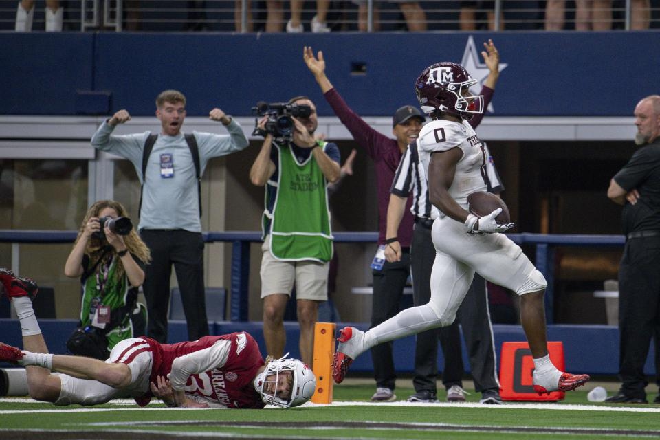 Sep 30, 2023; Arlington, Texas; Texas A&M Aggies wide receiver Evan Stewart (1) returns a punt for a touchdown Arkansas Razorbacks punter Devin Bale (37) cannot make the tackle during the second half at AT&T Stadium. Jerome Miron-USA TODAY Sports