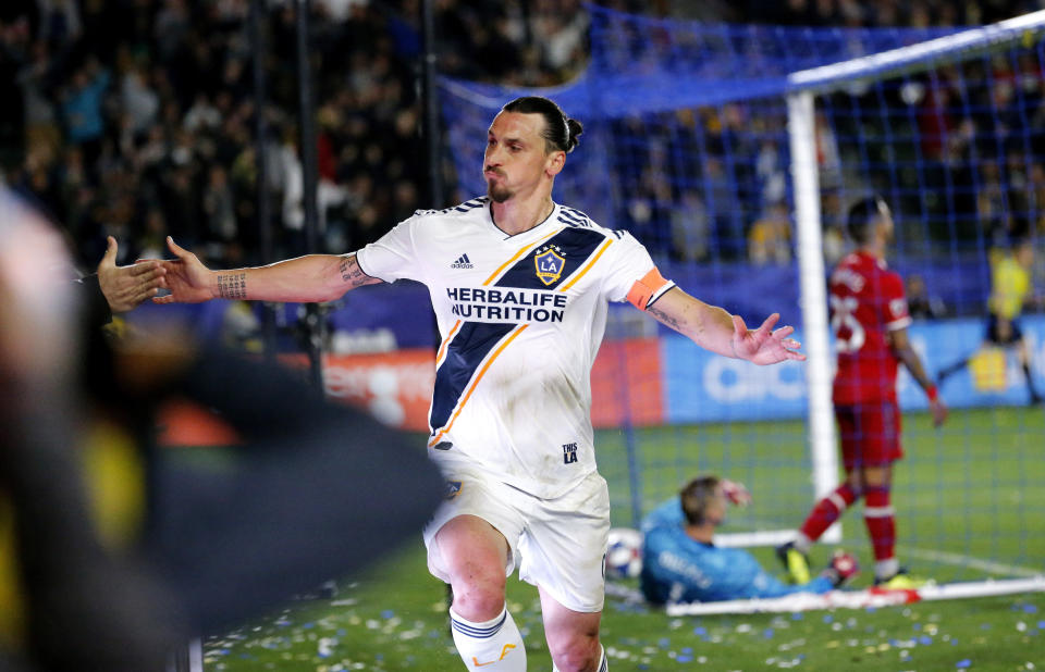 LA Galaxy forawrd Zlatan Ibrahimovic, left, of Sweden, celebrates his goal against the Chicago Fire in the second half of an MLS soccer match in Carson, Calif., Saturday, March 2, 2019. (AP Photo/Ringo H.W. Chiu)