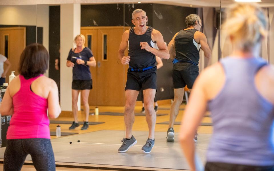 Mark teaching a fitness class at the gym where he now works - Heathcliff O'Malley for The Telegraph