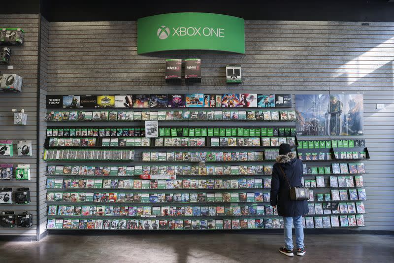 A person browses games at an XBox One Display in a GameStop in Manhattan, New York