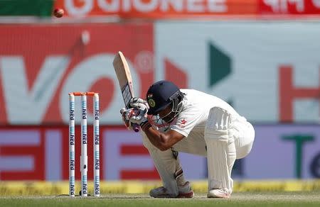 Cricket - India v Australia - Fourth Test cricket match - Himachal Pradesh Cricket Association Stadium, Dharamsala, India - 27/03/17 - India's Wriddhiman Saha ducks to evade a bouncer. REUTERS/Adnan Abidi