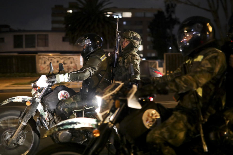 Soldiers patrol in Bogota, Colombia, Saturday, Nov. 23, 2019. Authorities in Colombia are maintaining a heightened police and military presence in the nation's capital following two days of unrest. (AP Photo/Ivan Valencia)