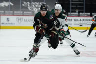 Arizona Coyotes left wing Lawson Crouse (67) shields Minnesota Wild left wing Marcus Foligno from the puck during the second period of an NHL hockey game Friday, March 5, 2021, in Glendale, Ariz. (AP Photo/Rick Scuteri)