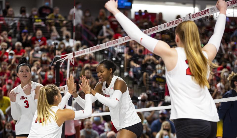 Ohio State's Arica Davis high-fives setter Mac Podraza (10) earlier this season. The Buckeyes are 25-5 and the No. 9 seed in the NCAA tournament.