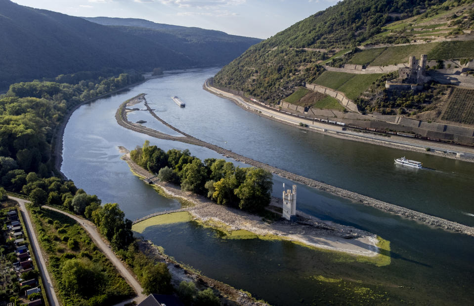 The "Maeuseturm" (mice tower) is pictured in the middle of the river Rhine in Bingen, Germany, Friday, Aug. 12, 2022. The Rhine carries low water after a long drought period. (AP Photo/Michael Probst)