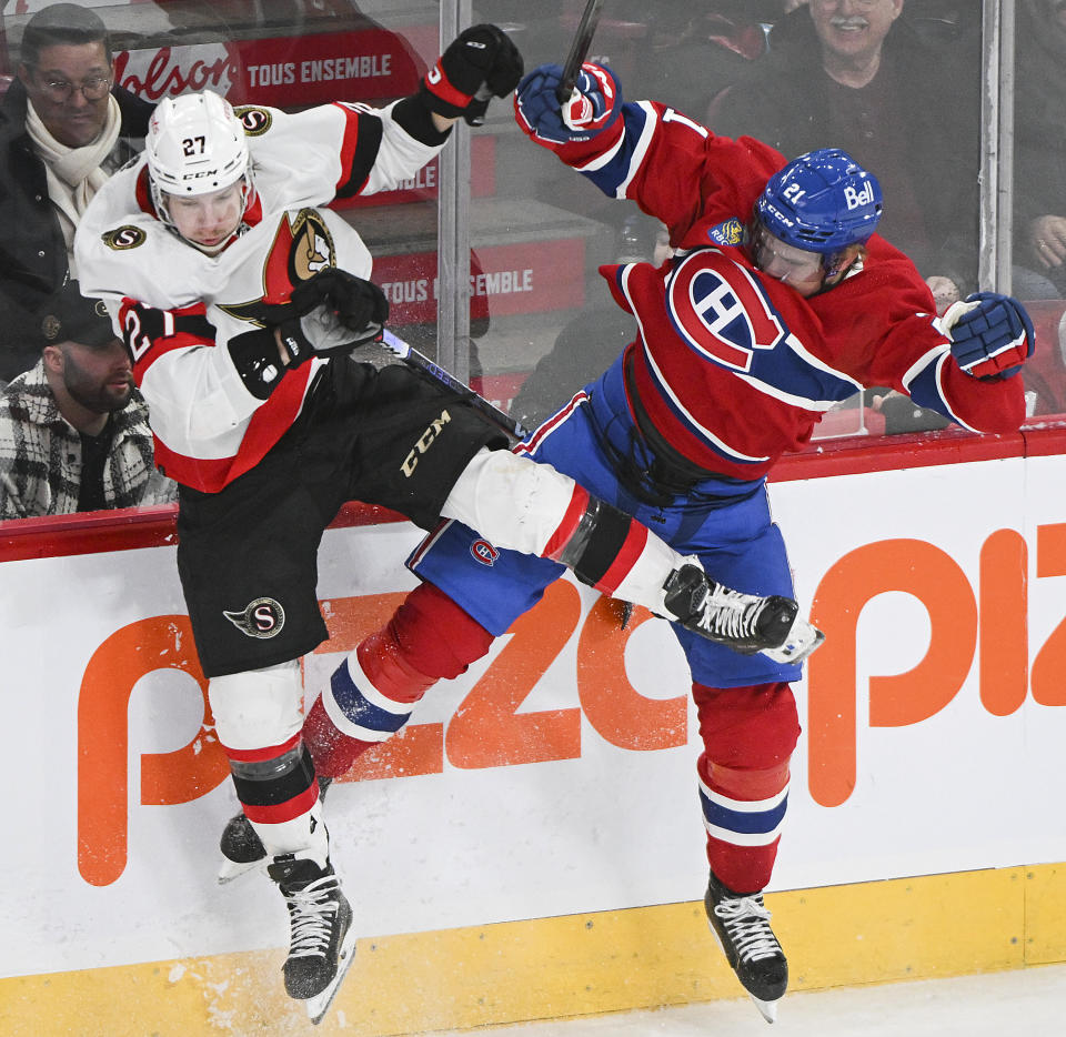 Montreal Canadiens' Kaiden Guhle (21) collides with Ottawa Senators' Parker Kelly (27) during the first period of an NHL hockey game in Montreal, Tuesday, Jan. 23, 2024. (Graham Hughes/The Canadian Press via AP)