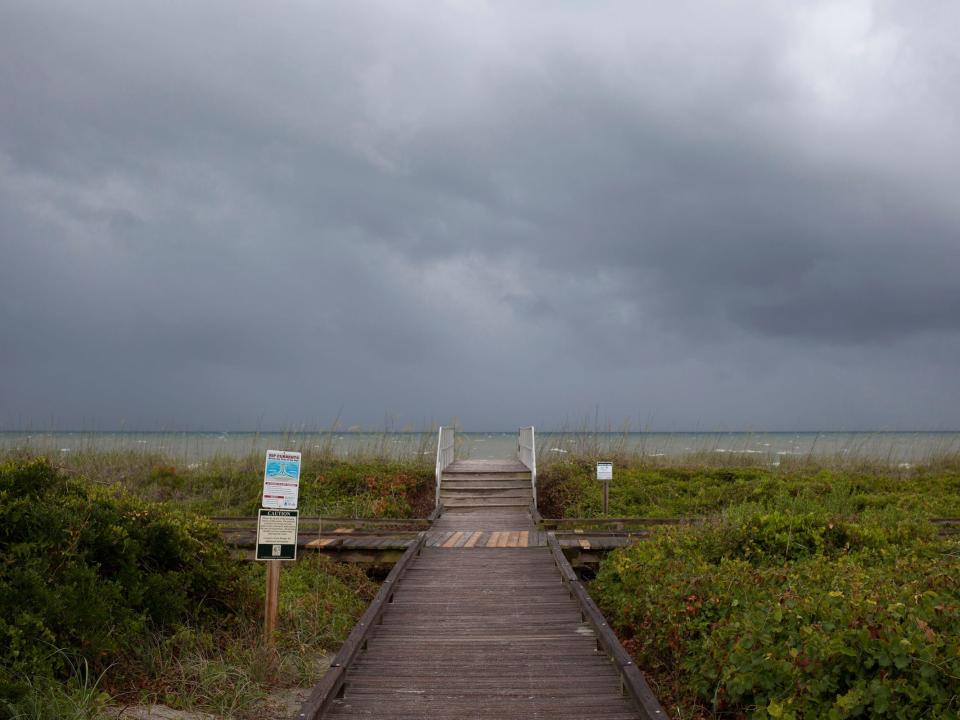 beach walkway cloudy skies