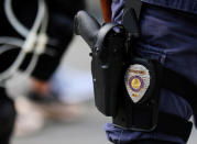 <p>The badge and gun of a Charlotte police officer in riot gear are seen during a large security presence outside the football stadium as the NFL’s Carolina Panthers host the Minnesota Vikings amid protesting of the police shooting of Keith Scott in Charlotte, N.C., on Sept. 25, 2016. (Mike Blake/Reuters)</p>